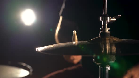Hands of Musician Drummer Holding Drum Sticks Hitting on Hihat Cymbal alt