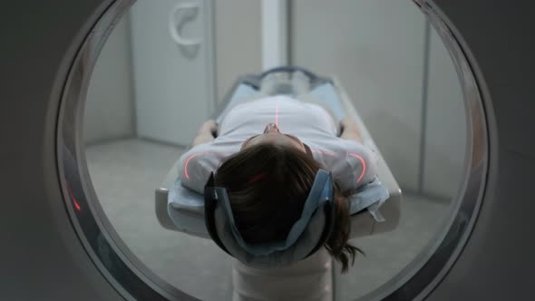 Female Patient On The Ct Or Mri Scanner Machine During X-Ray Process alt