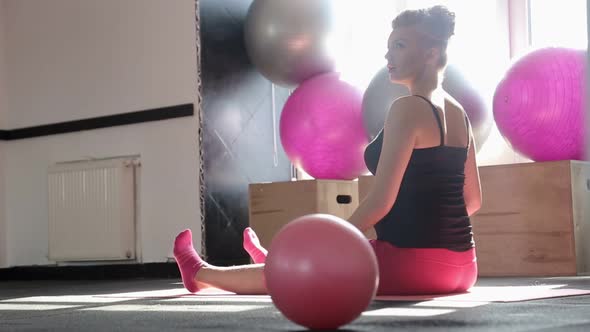 Pregnant Woman Performing Stretching Exercise on Fitness Ball in Office alt
