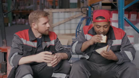 Workmen Having Lunch In Stockroom alt