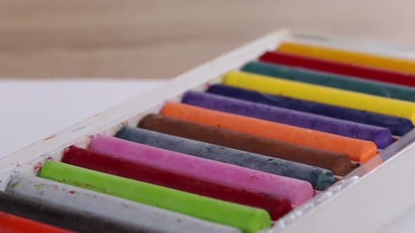Colored Pastels For Drawing.  In Open Packaging. Slider Camera. Shooting Diagonally. Close Up