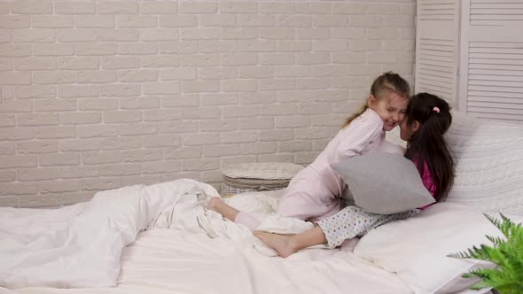 Two Cute Children Girls Playing in the Bedroom