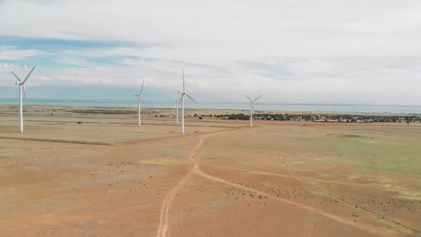 Aerial View of Wind Turbines Near the Lake alt