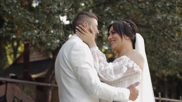 Newlyweds Caucasian Groom with Bride Walking Embracing Hugs in Park Wedding Couple in Love alt