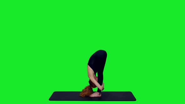 Beautiful Athletic Female Doing Yoga Exercises On Mat Against Green Screen