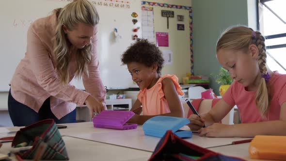 Female teacher teaching kids in the class alt