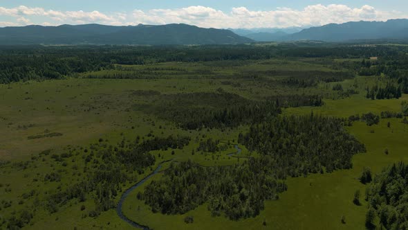 Aerial drone in Bavaria at Kirchsee Kirchseemoor Moor at Bad Tölz close to the alps mountains toward alt