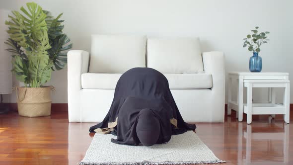 Young Muslim female praying and practicing the Islamic faith