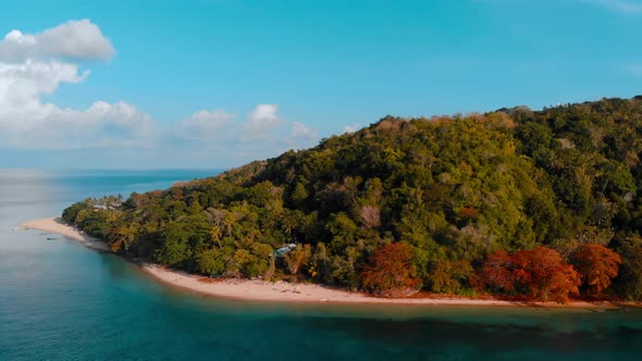Aerial: flying over tropical island white sand beach Banda Islands Indonesia alt