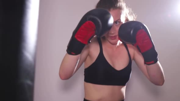 Strong Young Girl Trains in the Boxing Hall alt