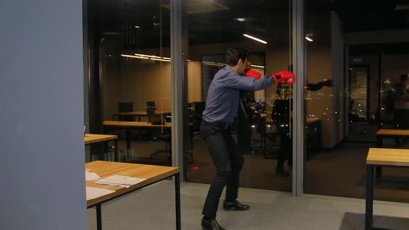 Angry Energy in Work. Businessman Fighting in Boxing Gloves alt