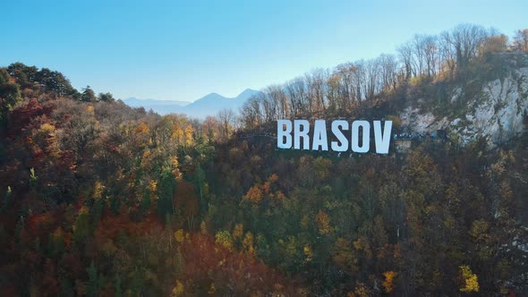 Brasov sign on the top of the hill near the city, yellowed trees, Romania alt