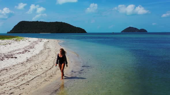 Modern Beauty Models on Vacation Enjoying Life on Beach on Sunny Blue and White Sand alt