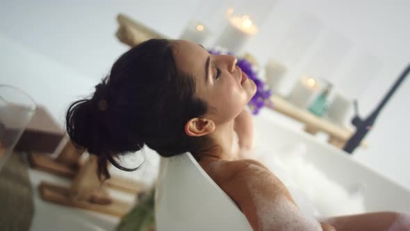 Closeup Romantic Woman Taking Bath at Home. Sensual Girl Relaxing in Foam Bath. alt