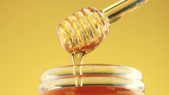 Closeup of Honey Spoon with Pouring Honey alt