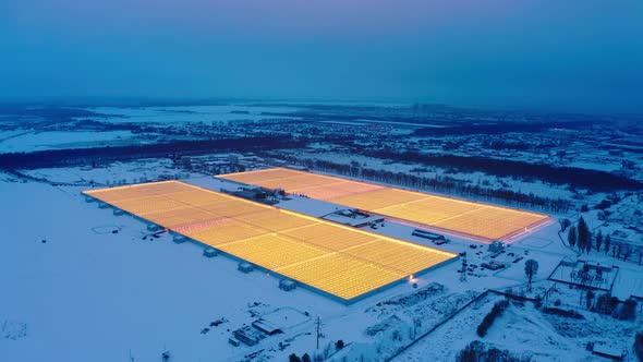 Aerial Side View of Large Industrial Greenhouses for Growing Plants in Winter
