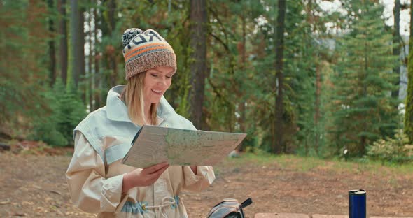 Slow Motion Pretty Smiling Woman in Green Forest. Young Female Exploring Map alt