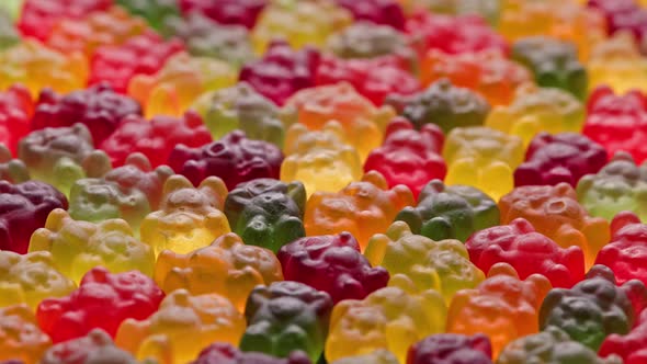 Full Frame Looped Spinning Background of Colorful Jelly Bear Candies alt