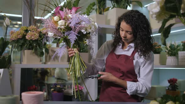 Floral Artist Cutting Flower Stems in Workshop alt
