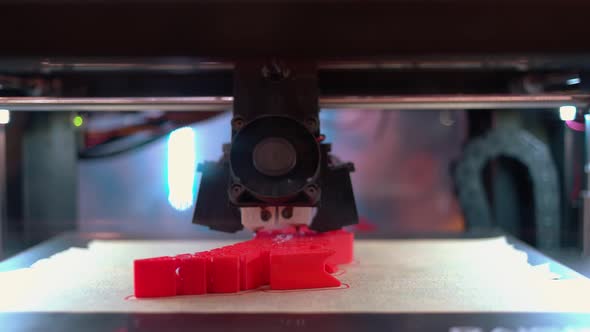 Closeup of 3d Printer is Making a New Red Model Shape alt