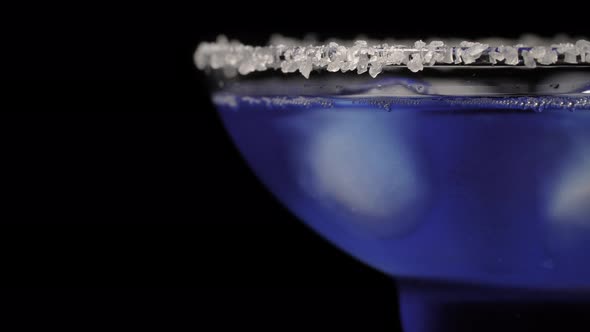 Cocktail of Blue Color on Black Background. Alcoholic Drink Margarita with Ice alt