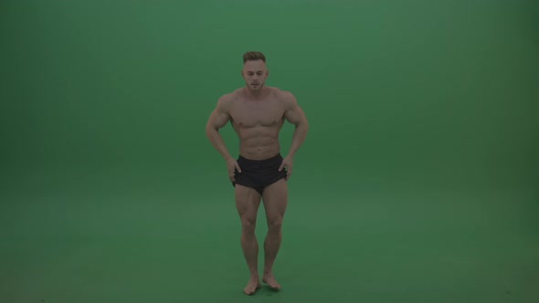 Sportsman Showing Front Double Biceps And Thigh Muscles Bodybuilding Positions On Gren Screen  alt