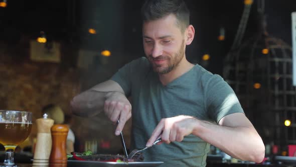 Man Eating Food At Restaurant, Cutting Meat Steak With Knife alt