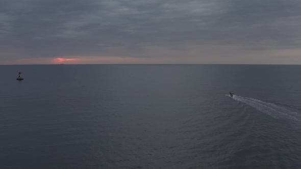 Boat With Lighthouse At Cloudy Sunrise