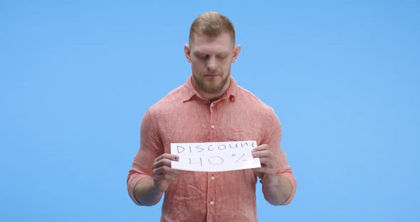 Young Man Holding Discount Sign alt