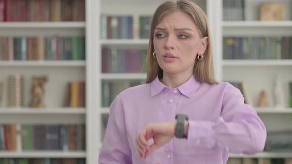 Woman Waiting While Checking Watch on Smartwatch alt