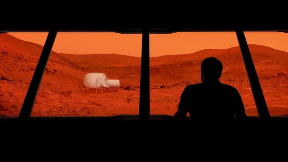 Astronaut Looks Out At Mars Base alt