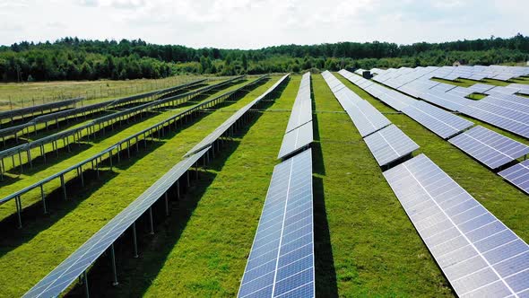 Many rows of solar panels on the field. alt