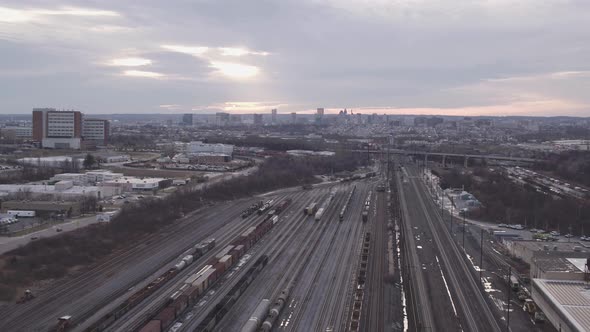 Overview clip of sunrise over the horizon of a train yard alt