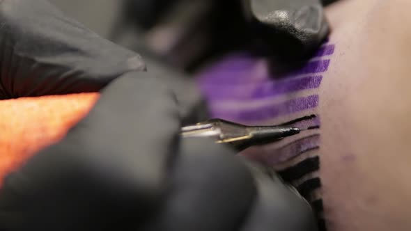 Tattoo Artist Draw the Line on Skin of His Client, Macro View on the Needle alt