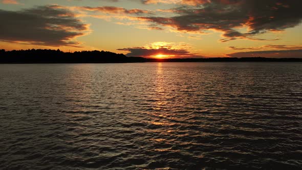 Epic Aerial View of Big Lake With Clear Blue Water. Reflection of Sky and Sun alt