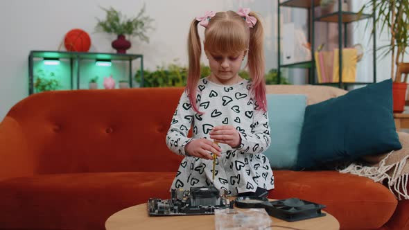 Little Smart Teen Child Girl with Screwdriver Repairs Computer Motherboard Electronic Fan at Home alt