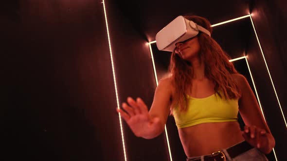 Lady Using VR Goggles in Neon Tunnel