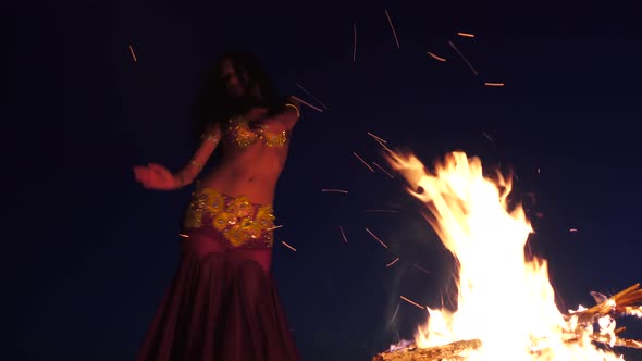 Girl in the Sand Dancing Belly Dancing Near a Bright Campfire alt