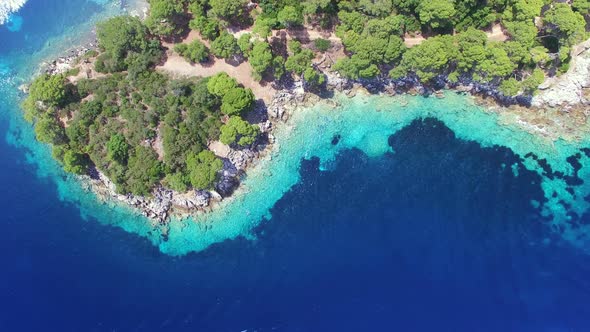 Aerial view of turquoise shallows contrasted with deep sea alt