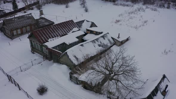 Old Wooden Houses in the Russian Village Covered with Snow