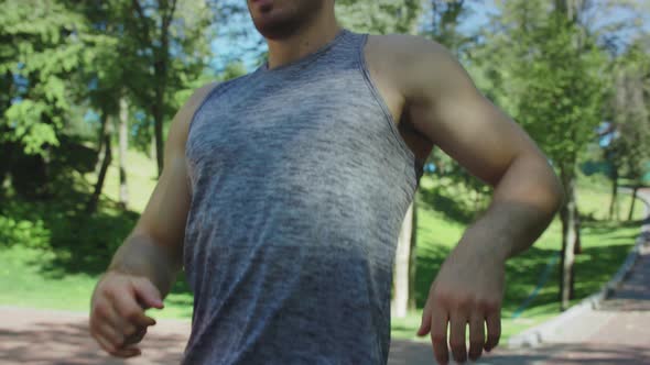 Portrait of Tired Runner Man Breathing After Run Marathon in City Park alt