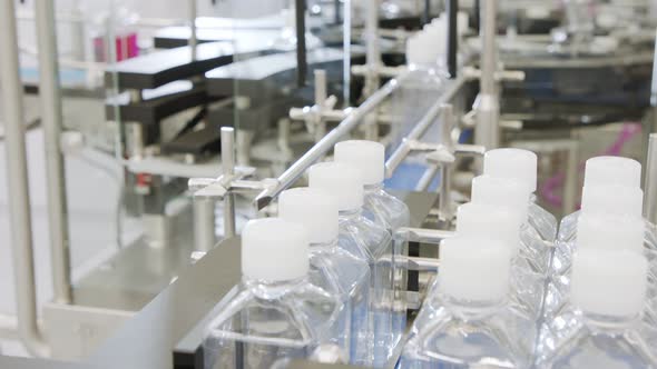 Automated pharmaceutical manufacturing line, bottles filled with liquid alt