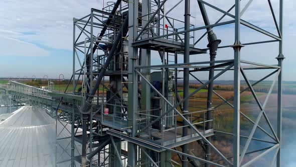 Manufacturing in the countryside. Steel frame of a modern plant on nature background.  alt