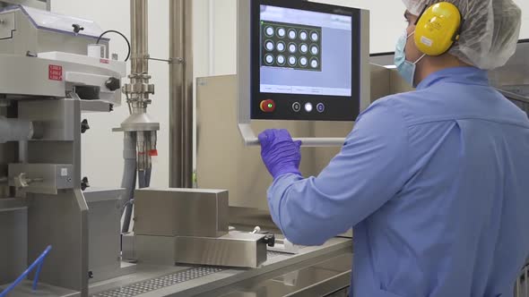 Pharmacist Control Pharmaceutical Manufacturing Process at Drug Factory Using Computer alt