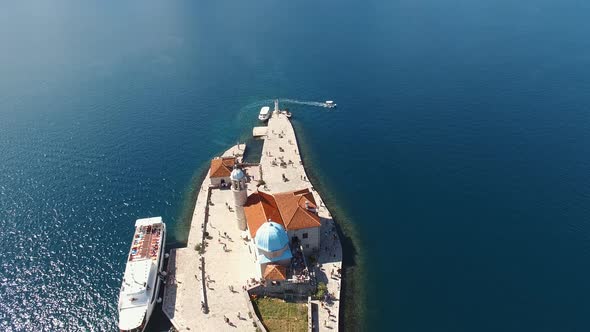 Tourists Walk Around the Church on the Island of Gospa Od Skrpjela alt