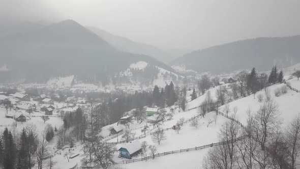 Calm and cosy fairy-tale village Kryvorivnia covered with snow in the Carpathians mountains alt