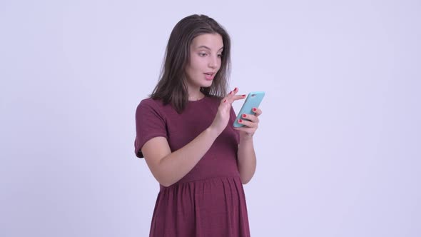 Happy Young Beautiful Pregnant Woman Using Phone and Getting Good News alt