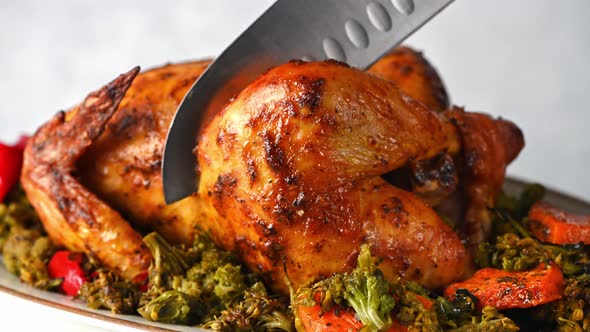 Carving baked chicken. Serving baked chicken. Comfort food. Taking a piece of chicken. alt