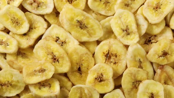 Dried sweet banana chips close up full frame  alt
