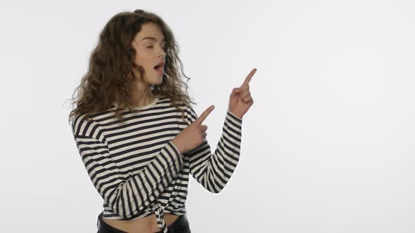 Young Woman Advertising Product with Hand Gesture on White Background alt